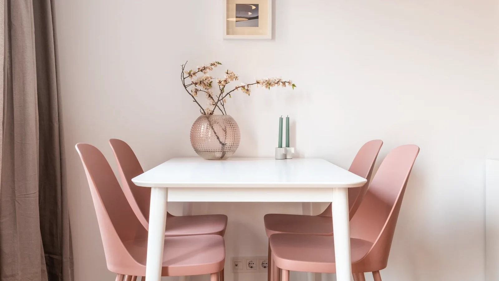 A dining table and chairs in a bright room